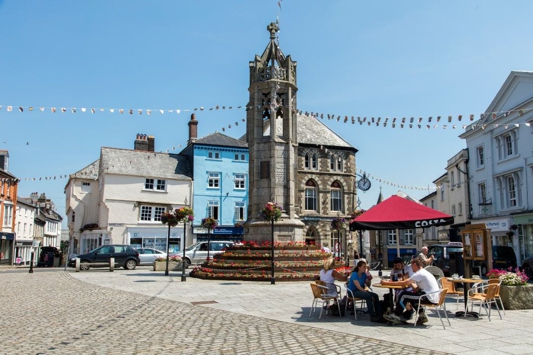 Historic Launceston Castle and town center showing the ancient Norman keep overlooking local businesses